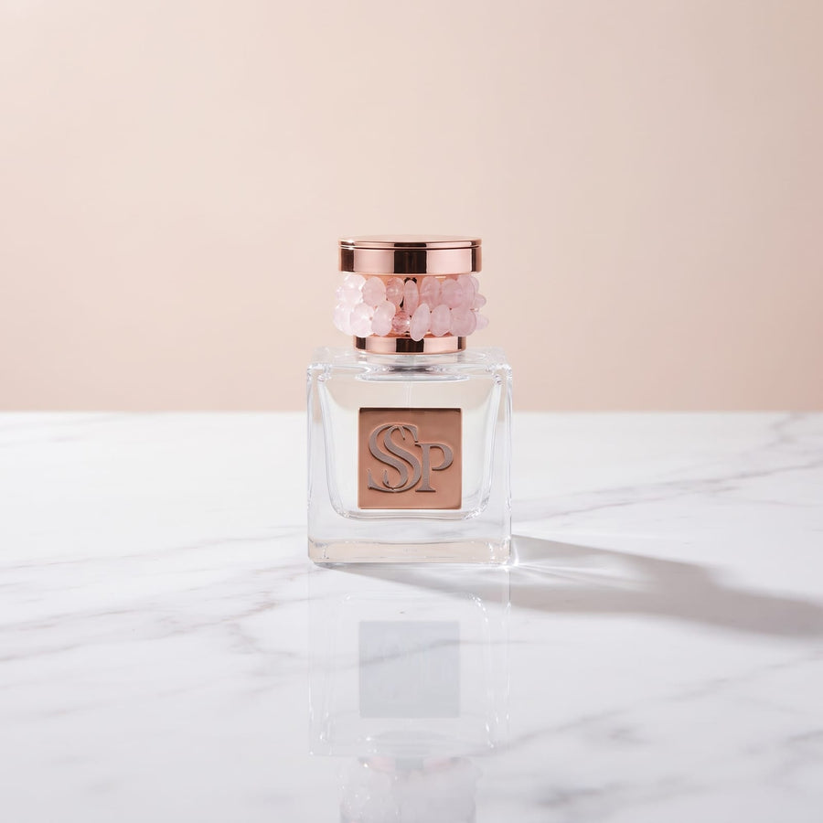 Lumière Soleil Extrait de Parfum, square glass bottle with a rose quartz and rose gold cap and rose gold SSP plaque